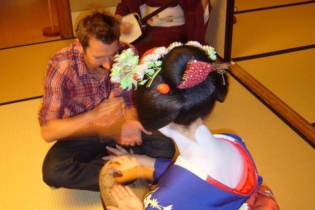 Guests are playing with Maiko at a tea house