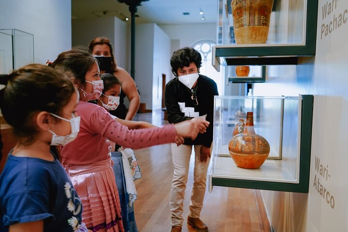 Our guide Anita explaining some pieces from our Precolombian collection to a family